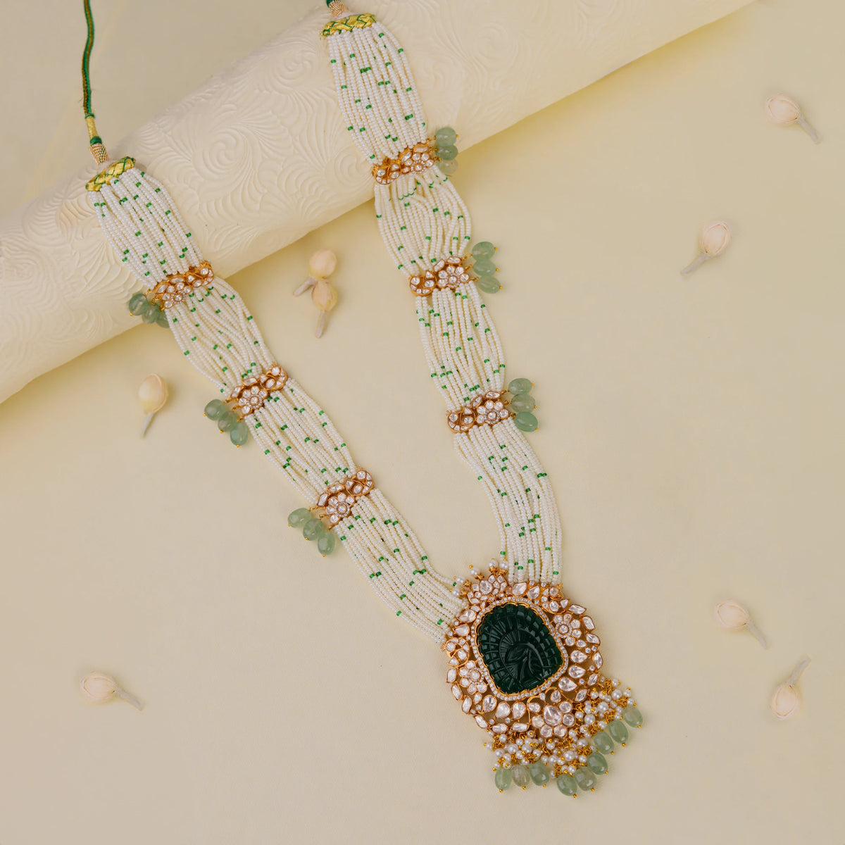 traditional jadau maala with uniquely carved emerald stone in mozanite stones and pearl strings