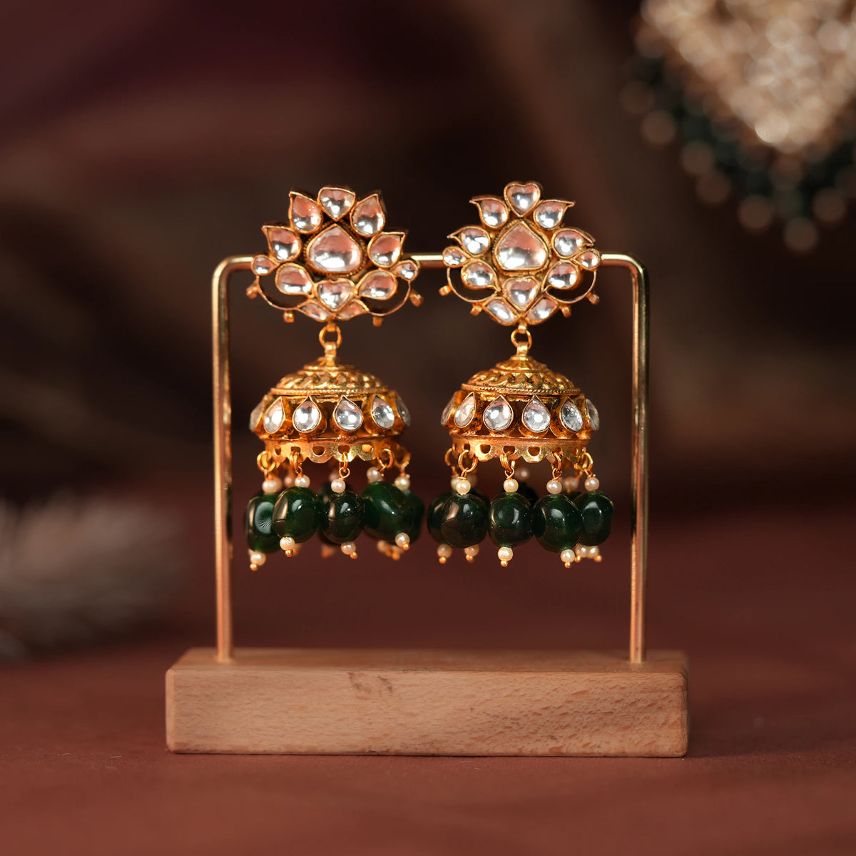 Long floral necklace with pendant design and emerald jhumkis in traditional style