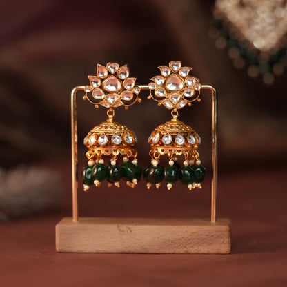 Long floral necklace with pendant design and emerald jhumkis in traditional style