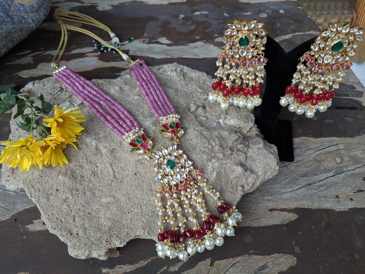 long pink string pendant necklace with green, white and red stones