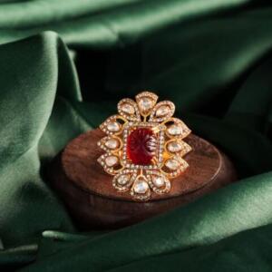 gold Plated ring with a central carved red gemstone