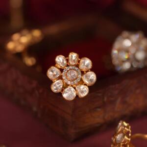 gold plated ring  featuring a floral design with uncut moissanite stones