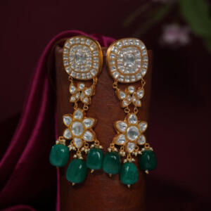 gold-toned kundan jadtar earrings with white stones and Emerald tumble beads.