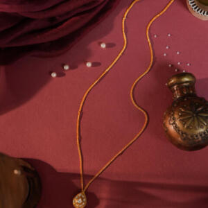 gold-plated pendant necklace featuring jadtar stones in a pear or teardrop shape