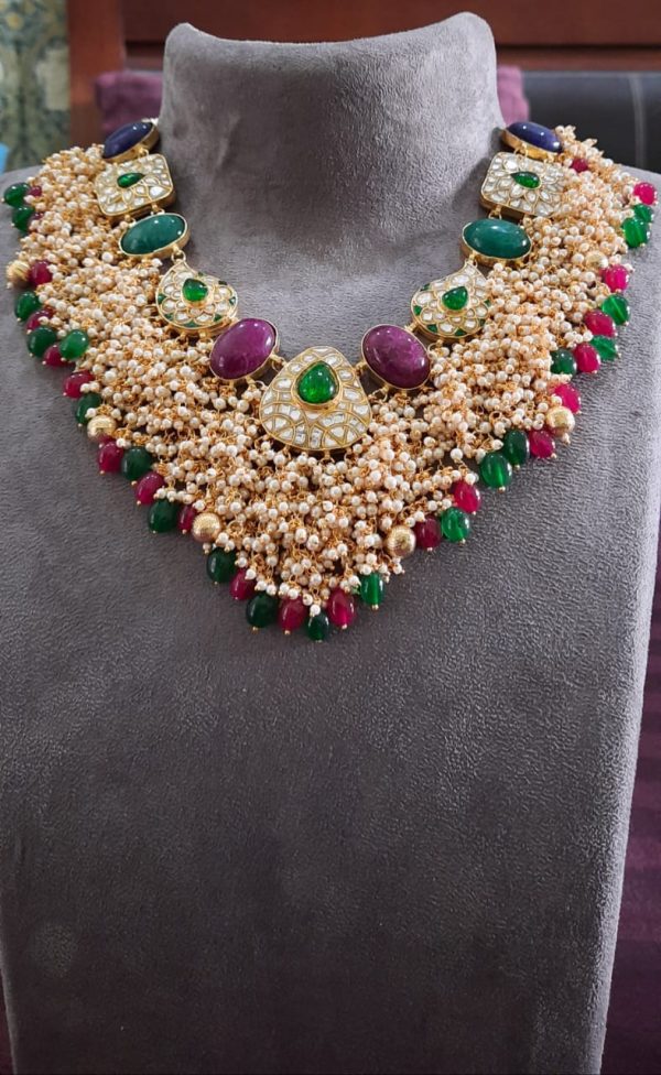 UNIQUELY DESIGNED NECKLACE STUDDED WITH RED AND GREEN STONES