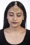 Maang tikka with pink jadtar stones and a touch of green with pearls