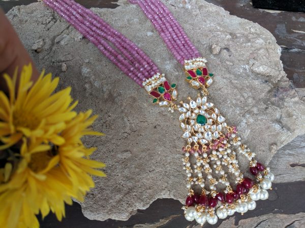 long pink string pendant necklace with green, white and red stones