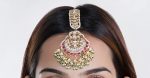 Maang tikka with pink jadtar stones and a touch of green with pearls